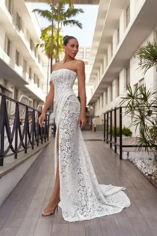 Oksana Mukha Amina Wedding Gown - Fitted strapless gown made of all-over floral lace featuring a slit skirt and gathered train.