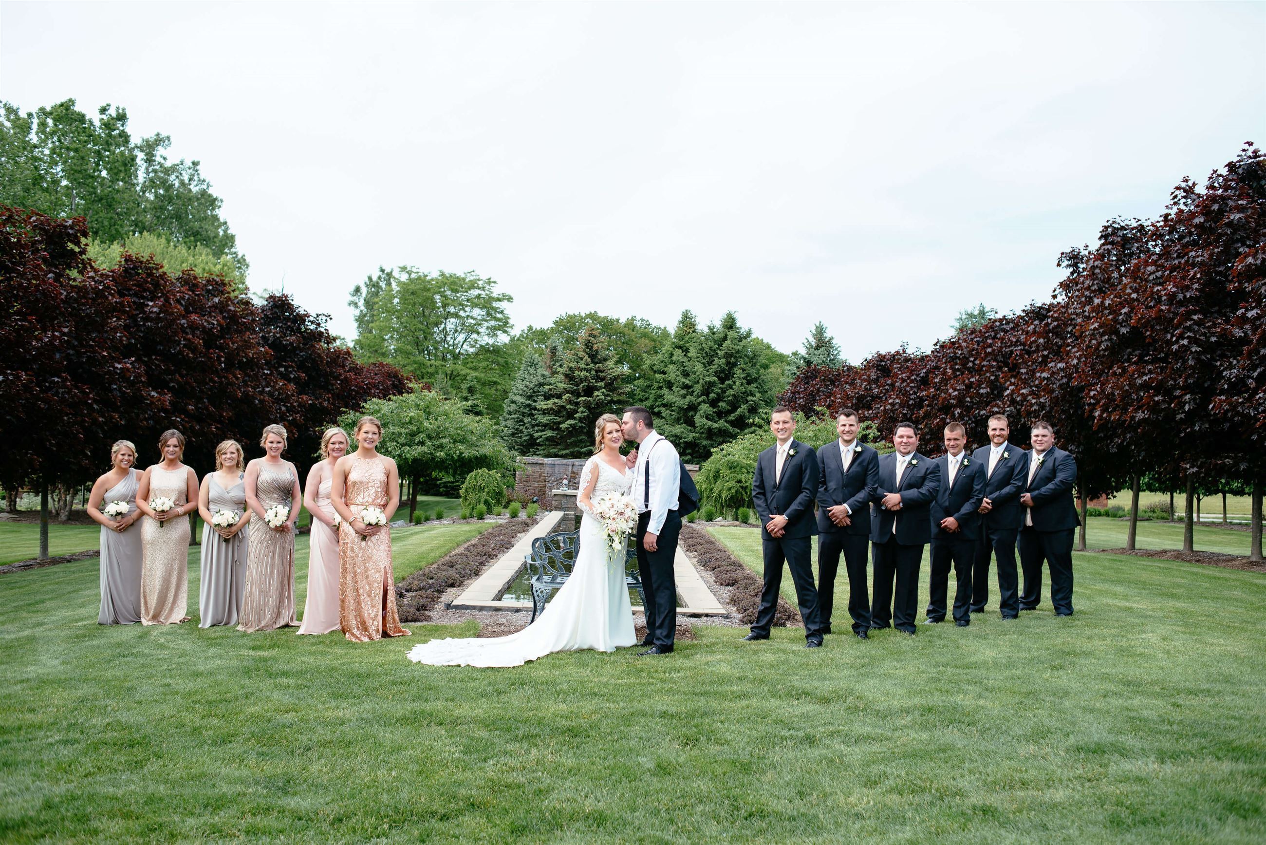 Fantastic Finds couple, Lindsey and Patrick, posing and kissing on their wedding day in between