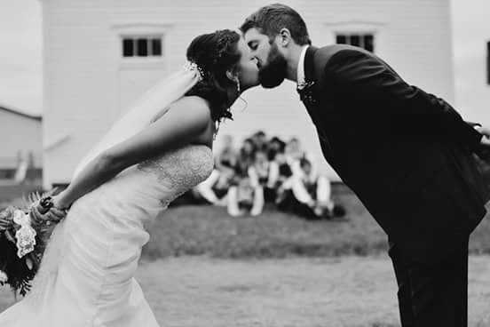 Fantastic Finds couple, Michaela and Jon, leaning into each other and kissing on their wedding day